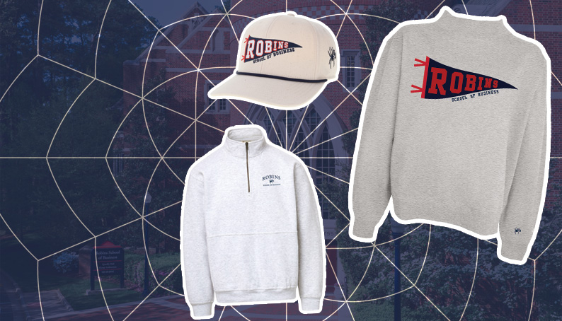 The new Robins merch are in front of a pictuer of the robins school of business