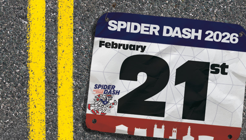 A racing bib that says 'Spider Dash 2026, February 21st' lays on a road.